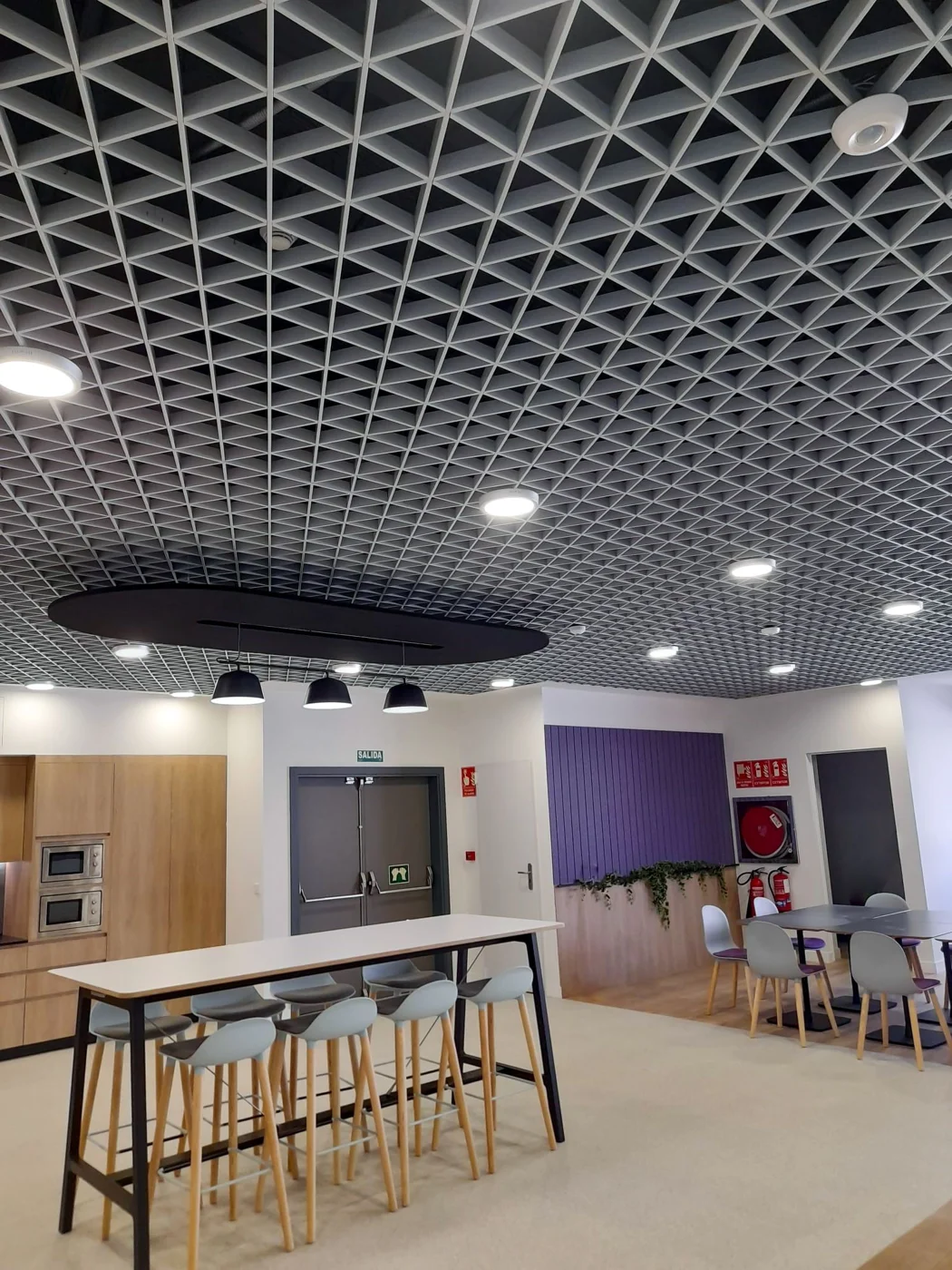 Finished interior with coordinated ceiling lighting and communal seating