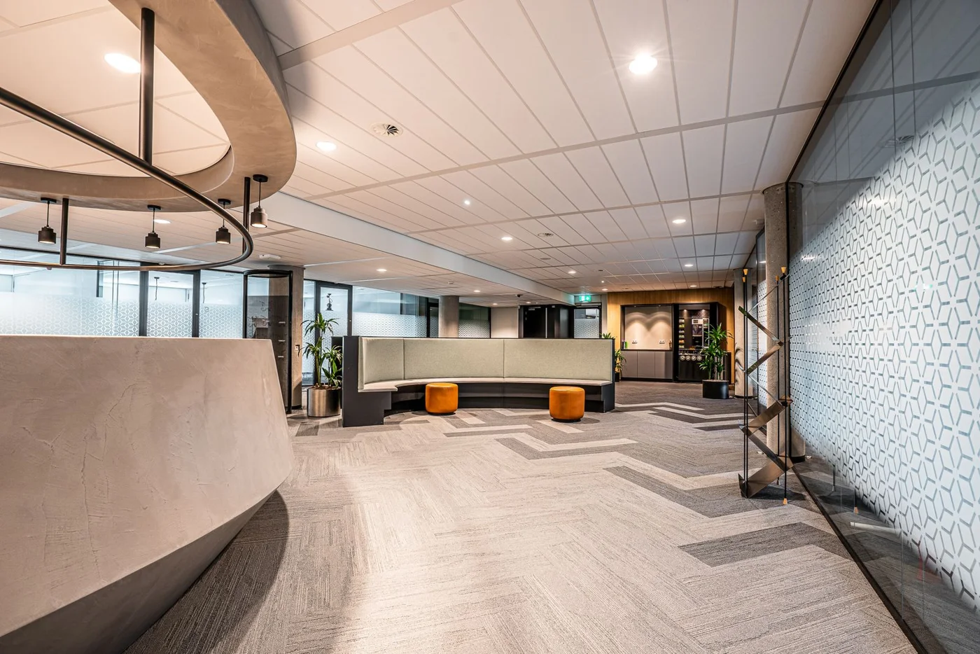 Bright lobby with coordinated ceiling lighting and seating