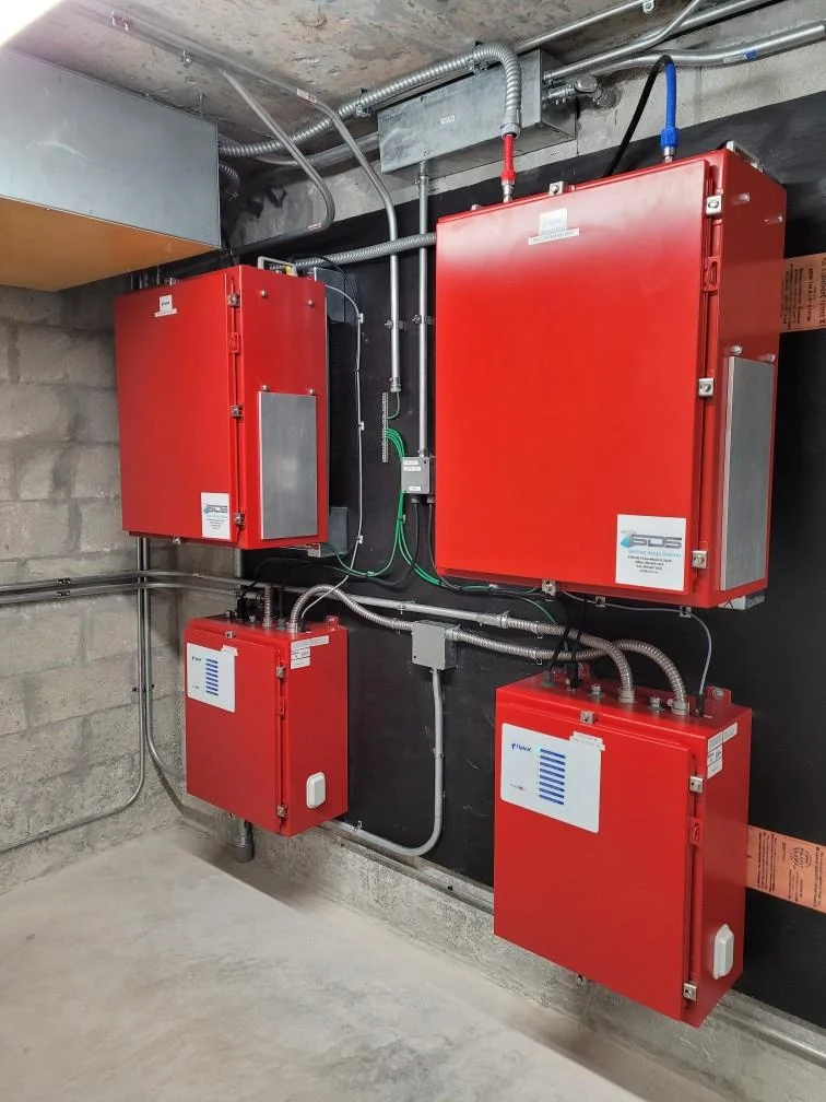 Wall-mounted red BDA equipment enclosures and conduit
