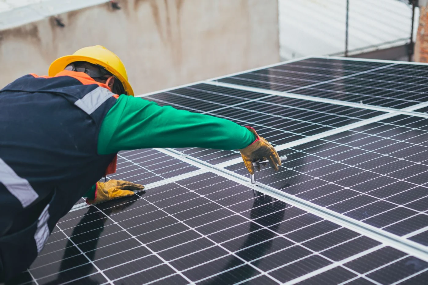 A worker positioning a solar panel