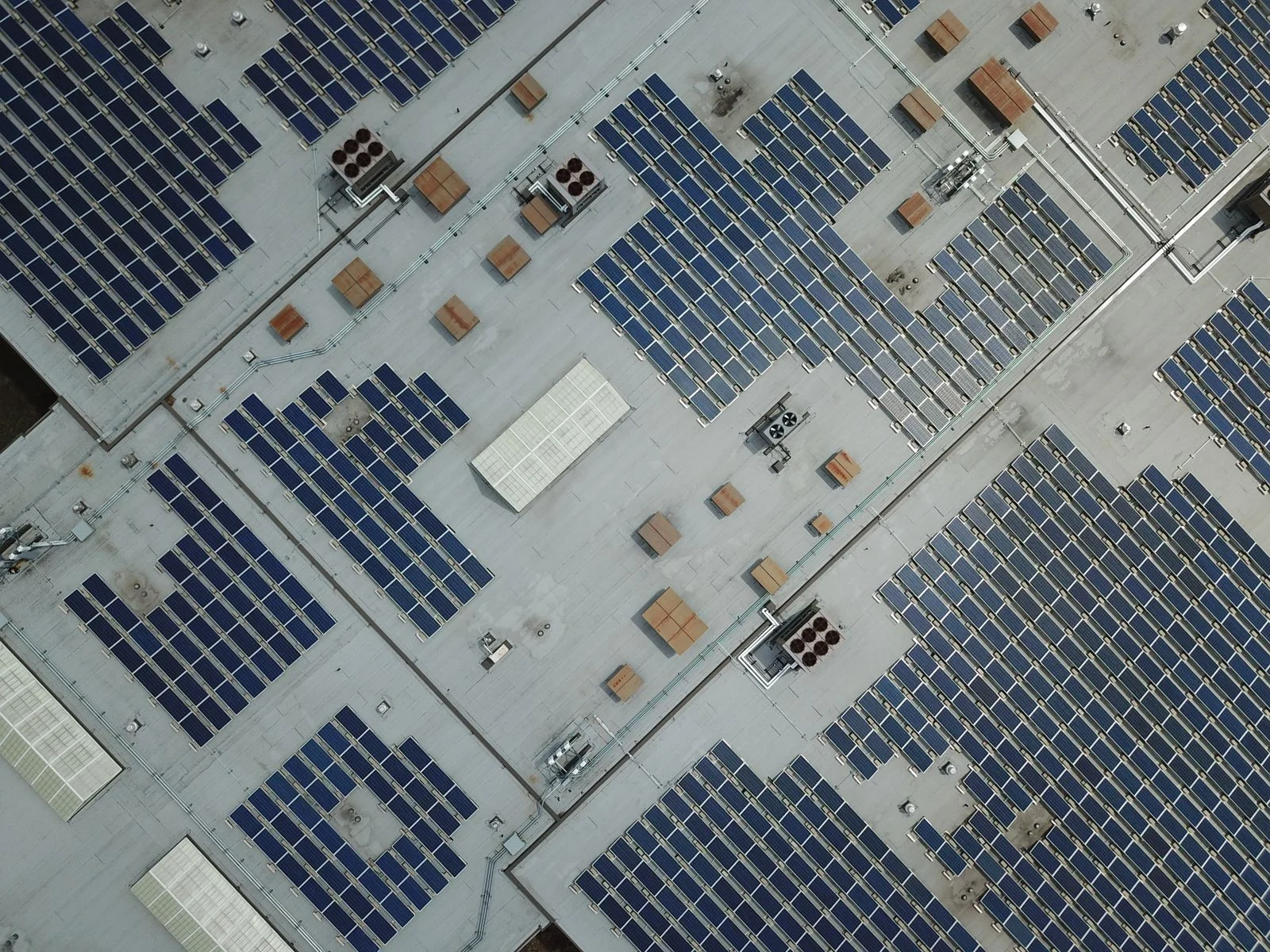 Photovoltaic panel arrays on a building roof